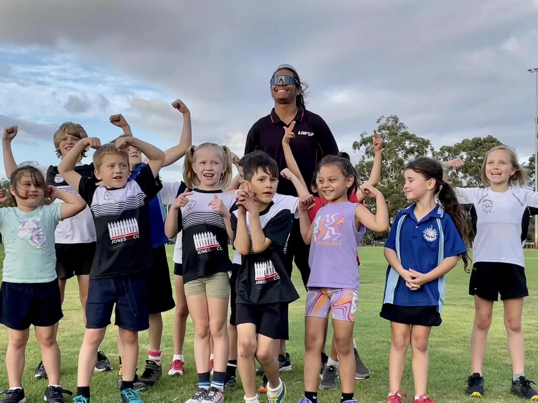 Eden Hill little athletes celebrating together on the oval
