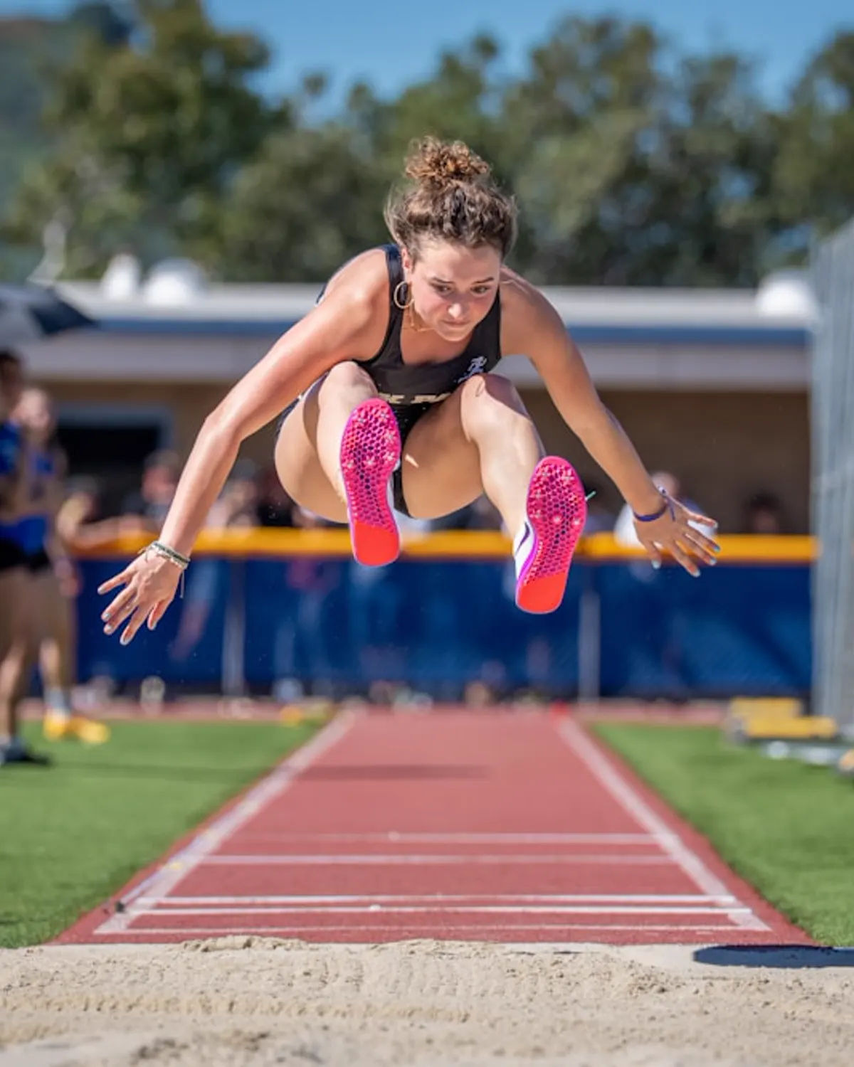 Athlete soaring through a long jump