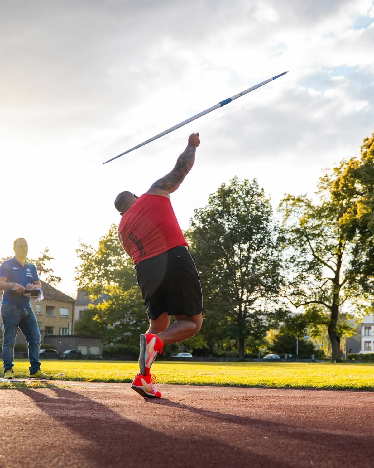 Athlete launching a javelin on an athletics field